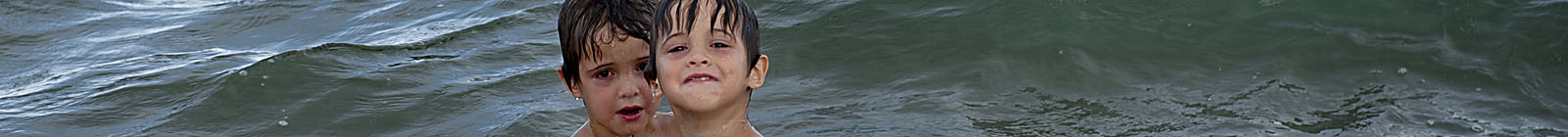 Chachalacas Beach, boys in water. - Banner