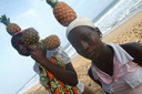 Girls on Grande Bassam beach, pinaples on their heads, Cote d'Ivoire.