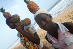 Tereso Hotel, Grand Bassam, African girls and pinaples on their heads on beach, North Atlantik Ocean
