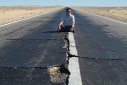 Broken asphalt desert road Egypt.