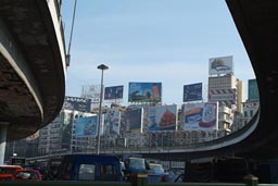 Cairo, flyovers, traffic, billboards on houses.