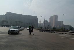Cairo, street, smog, veilled girls crossing.Tahrir square.