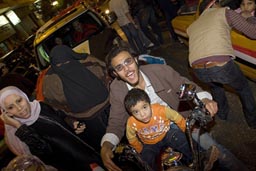 Man, woman, child, moped CAN 2010 Egyptian victory celbrations.