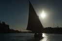 felucca silhuette against sun, Aswan Egypt.