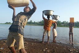 Children carry water in Africa from lake