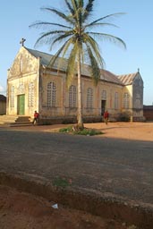 Church, Palm tree, road, two men. Danyi, Togo