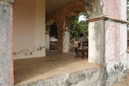 Bubaque, prefecture, man sitting on chair, Arquipelago dos Bijagos. Islands. Guinea Bissau.