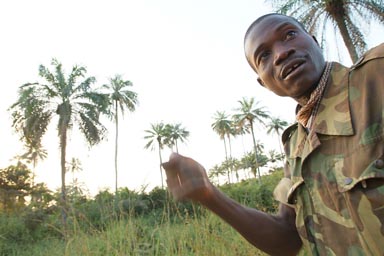 Jacques in uniform, palm trees in back, sunset light.