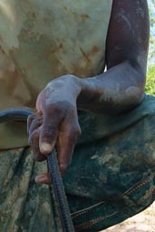 Vidor Pluvogui, Water from waterhole, her hands, Guinee, Guinea, Macenta.
