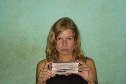 Liz Barker holding a pack of Guinean Francs.