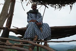 North of Guinea, Mali to Touba, near Medina Wora, Man on look out post with stone throwing device.