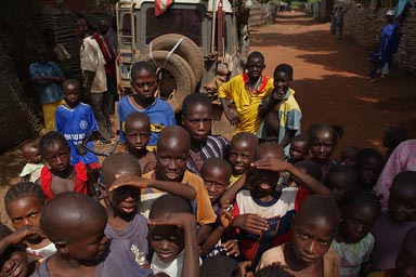 North of Guinea, village of Touba, Land Rover, lots many African children, with nig smiles, all want to be on the picture.