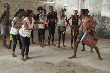 Lansana Camara and Sangban, drumming up large group of female dancers. Ballet Sanke Guinee.