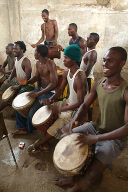 Djembe players, six, one behind the other, rehearsing Guinea.