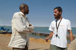 Mamou Daffe, director of the festival talking to Nico, stage and beach in the making in the background