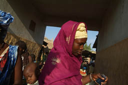 Woman with baby on back.