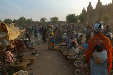 Mud mosque, Woman with baby on back, market.