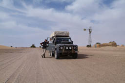 Hasna and Land Rover and wind mill, Sahel, Mali