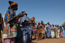 Koredugaw group of women watching, clapping.