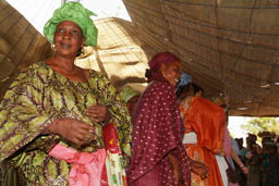 Women dance inside the tent.