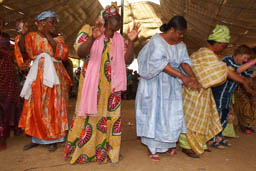 Women dance inside the tent.