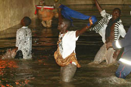 people in the water in front of stage.