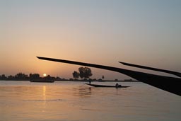 Mopti, silhouettes of pirogues, on Niger River, Evening, sunset behind, Mali.