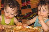 Daniel and David, 1 year olds, eating spaghetti.