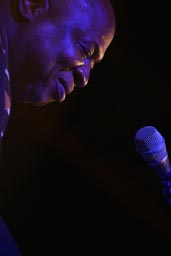 Cheik Tidiane Seck close up face magenta light.