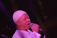 Salif Keita reddish face, eyes closed.