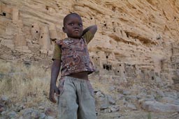 Mali, Tellem mud granaries in Bandiagara Escarpment, Dogon child in Irelli.