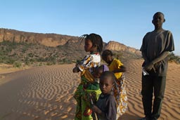 Peul children in Dogon land, on dunes, Cliffs in background.