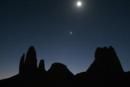 Nighttime falls over Hand of Fatima, moon shine, and stars. 