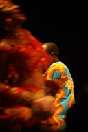 Femi Kuti behind dancer.