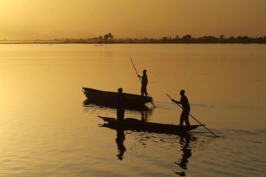 Golden sunset, 2 pirogues on Niger River.