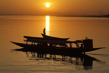 Golden sunest on the Niger River, pirogues.