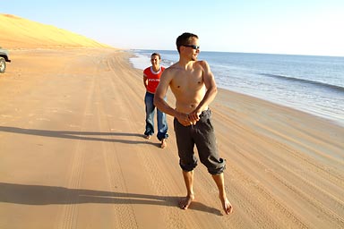 Cris and Hasna , tracks on the beach, flat sea