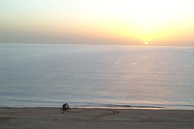 Cris taking last pictures of his Mitsubishi bus in front of the flat sea