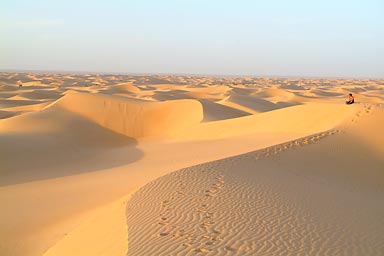 Hasna on a dune. Alone in the sand.