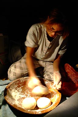 The evening Hasna is baking bread for the morning.