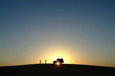 Another sunset in the desert, Land, Hasna, Cris infron of setting sun.