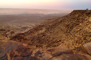 the sea of dunes below, after sunset