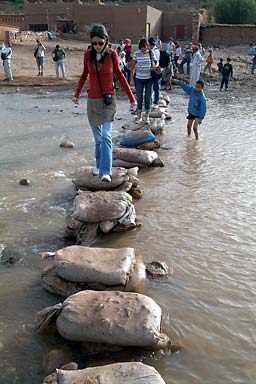 Back on the tourist trail, the girl is leading the pack over the river at Ait-Benhaddou