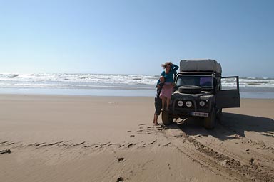 Floh and Anna on the windy beach next to the Land Rover