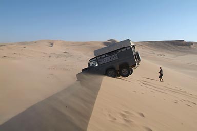 Flow and the Land Rover sitting on top of a dune
