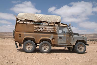 Dirty Land Rover, looks like camouflaged