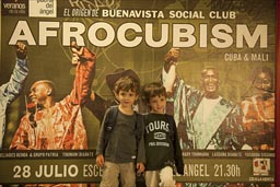 My twin boys in Madrid Metro in front of the Afrocubism bill board, I happen to know Toumani Diabate and Bassekou Kouyate from Mali too well.