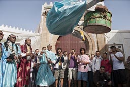 Gnaoua in Essaouira with drum jumps high.