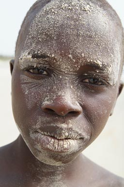 African boys on the beach, near Djembering, the sand on the face, Casamance.