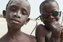 African boys on beach Djembering.